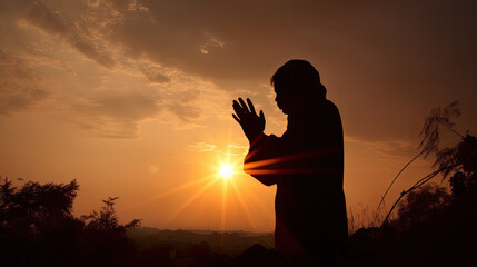 silhouette of a praying man outside at sunset. Generative AI