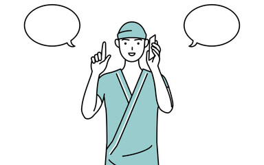 電話をしながら指さしをする男性入院患者