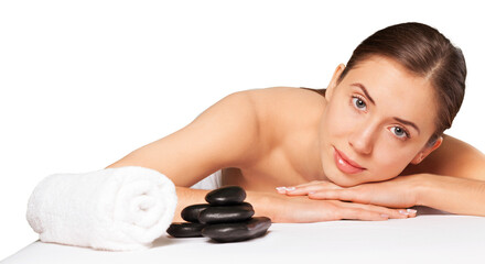 Obraz na płótnie Canvas Beautiful young woman receiving hot stone massage at salon spa
