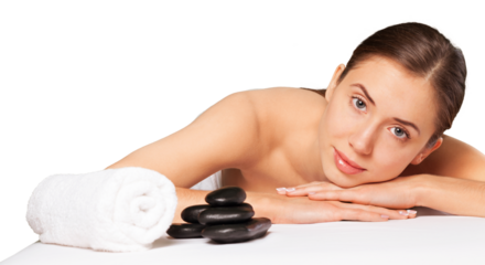 Beautiful young woman receiving hot stone massage at salon spa