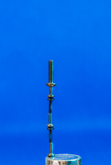 Obraz premium macro photography of a balanced stack of metal screws