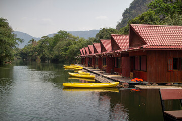 Houses on floating rafts with kayaks for tourists at Tha Farang, Thakhek City, Khammouane Province,...