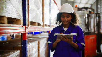 Young black woman warehouse workers holding digital tablet checking inventory management packaging...