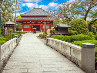 Capital of Japan. Tokyo province. ReligioUS temple. Buddhist building in park. Tokyo on summer day. Tour of capital of Japan. Sights of Japanese cities. Culture of east asia. Travel to Japan