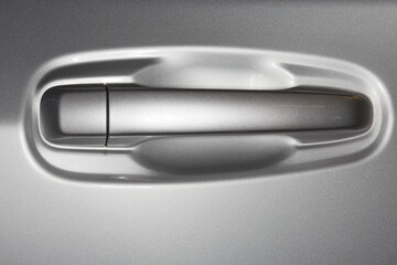 Close up of a Black Car Wheel Rim with Chrome Lug Nuts