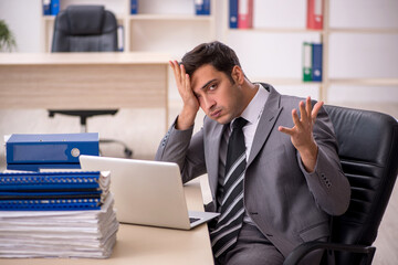 Young male employee working in the office