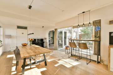 a dining room with wood flooring and white walls that have been painted in the same color as it appears