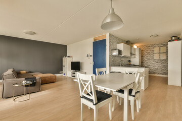 a kitchen and dining area in a modern apartment with wood floors, white furniture and blue accent wallpapers