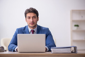 Young male employee working in the office