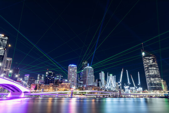 Brisbane city skyline at night with laser light show with the river in the foreground