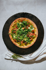 pesto veggie pizza with arugula  