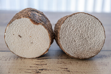 A tuber of yam cut in two ready for cooking