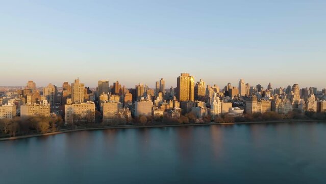 Aerial view of the Upper East Side cityscape, golden hour in New York, USA - tracking, drone shot