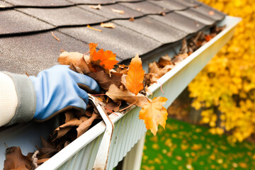 A man's hand cleaning leaves in a rain gutter on a roof, cleaning dirty gutters. High quality generative ai - obrazy, fototapety, plakaty