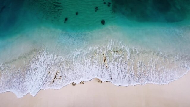 Fake aware letter  written on the beach sand and erased with a wave,and reveals  a new letter  concept video 