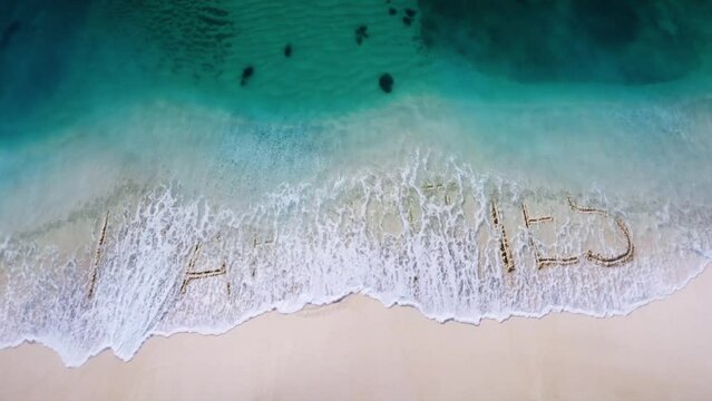 liabilities assets letter  written on the beach sand and erased with a wave,and reveals  a new letter  concept video 