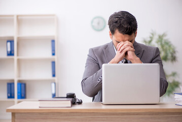 Young male employee working in the office