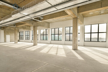 an empty office building with lots windows and light coming in from the sun shining through the window panoray