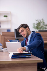Young male employee working in the office
