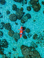 couple with a kayak on a small Island in front of the Island Ko Lipe Thailand
