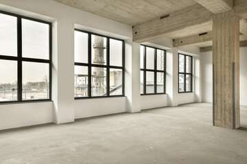 an empty room with large windows and lots of light coming in from the sun shining through the window panes