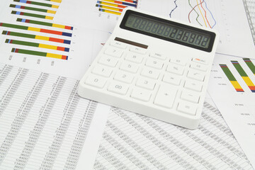 Naklejka na ściany i meble Modern calculator on papers with financial data.