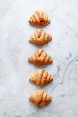 Croissants on a white stone background top view