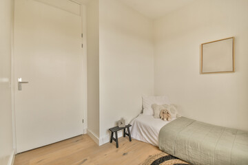 a bedroom with a bed, chair and mirror hanging on the wall in front of the door to the room
