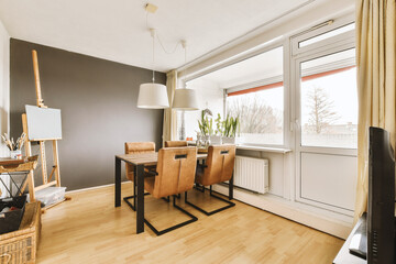 a dining room with wood flooring and white trim on the walls, there is a television in the corner
