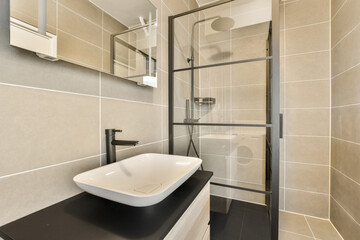 a bathroom with a sink, mirror and shower stall on the wall in this image is taken from above it