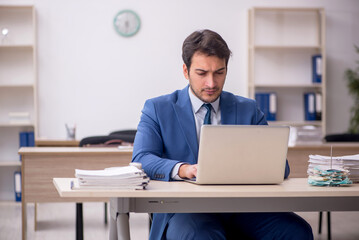 Young male employee working in the office