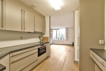 a kitchen with wood floors and stainless appliances on the counters in front of the oven, sink and dishwasher
