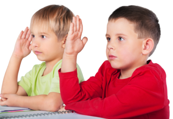 Two School Children Raising Hands in a Class