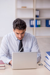 Young male employee working in the office