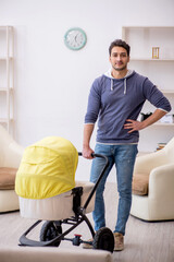 Young man looking after newborn at home