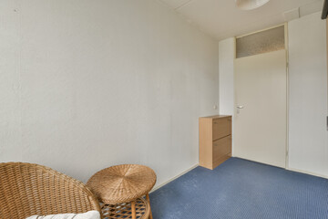 a room with two wickers on the floor and an open door to another room in the corner area