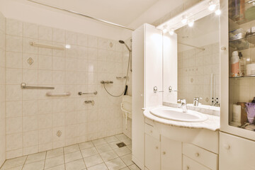 a bathroom with a sink, mirror and shower head mounted on the wall in it's corner to the right