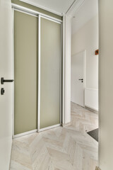 an empty room with two doors and one door open to the other room, which is very light green in color