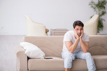 Young man starting day at home