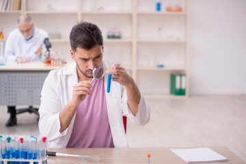 Two male chemists working at the lab