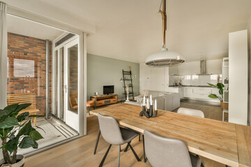 a living room and dining area in a house with sliding glass doors that open onto the patio to an outdoor deck