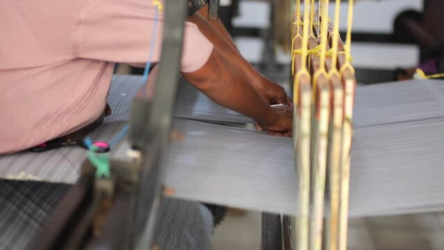 Selective focus traditional weaver is preparing yarn. Preparing the loom before starting to make woven ikat