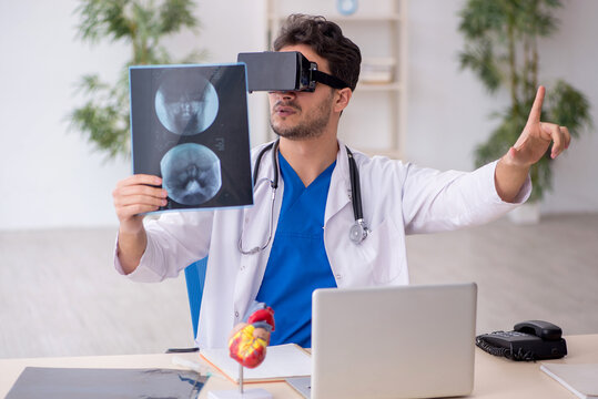 Young male doctor enjoying virtual glasses in the clinic