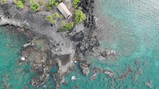 Aerial view on rustic house in hidden Kona Village with Bali style hideaway bungalows for expensive vacation of wealthy rich people. Scenic favorite vacation spot Kona Village Big Island Hawaii USA 4K