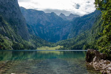 View across the clear and pristine waters of Lake Obersee in Germany's Berchtesgaden surrounded by majestic mountains