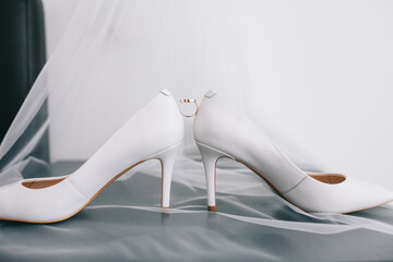 Delicate beautiful shoes of the bride with airy bows