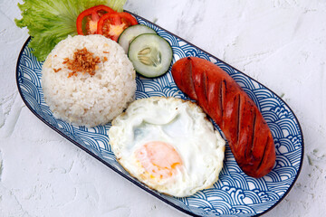 Freshly cooked Hungarian sausage served with fried rice and egg
