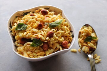 Jada Poha Namkeen Chivda or Thick Pohe Chiwda. Diwali special savory snack, made out of puffed rice, fried peanuts, curry leaves and some spices. Traditional Indian Diwali Snacks. with Copy Space.