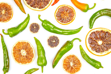 hot green peppers and dried citrus fruit on a white background. grocery organic flatley