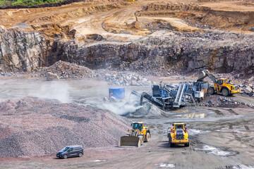 Loader tipping stones in a crushing plant in a quarry